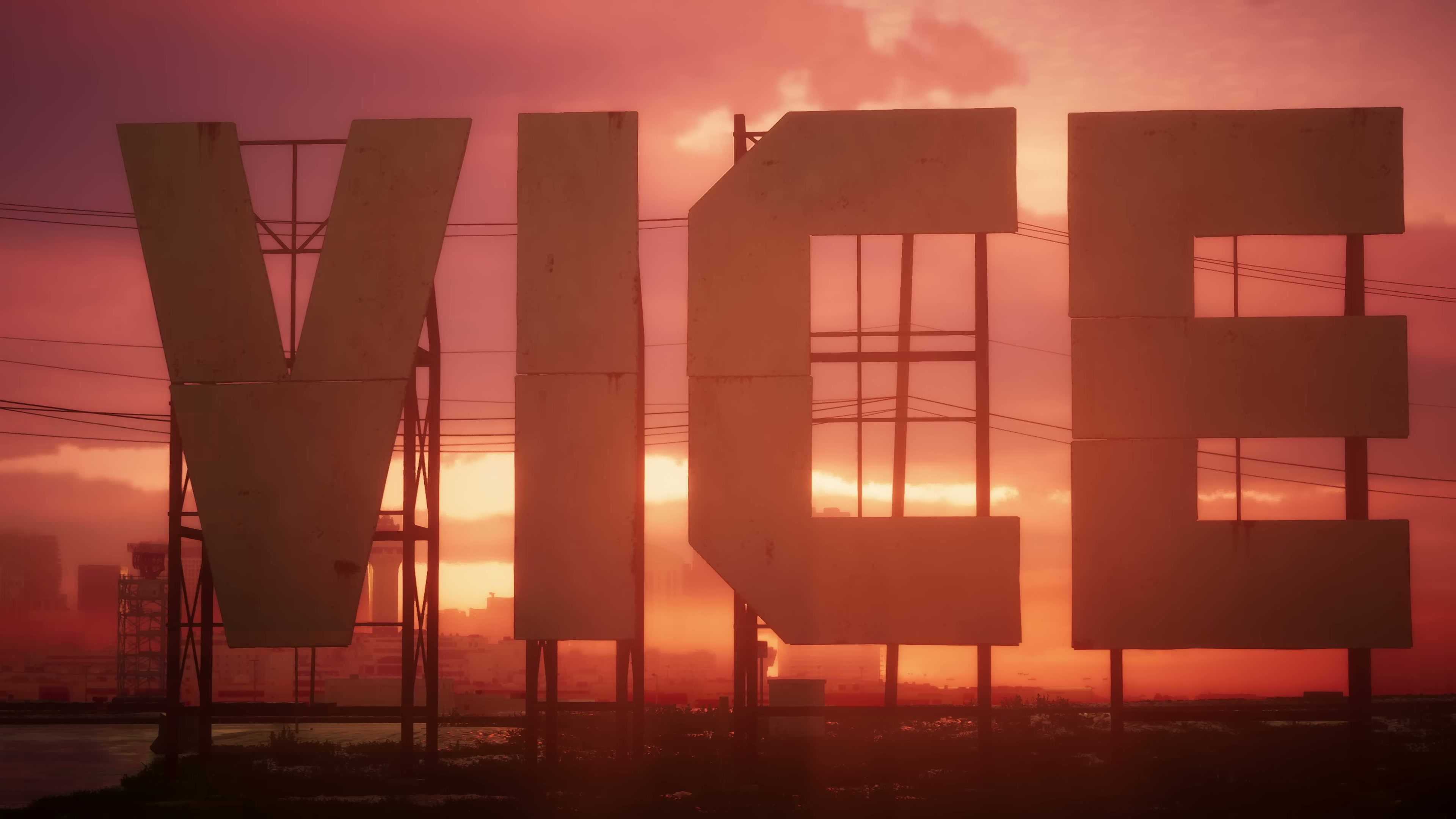 Freestanding 'VICE' letter signage against a red-orange sunset sky