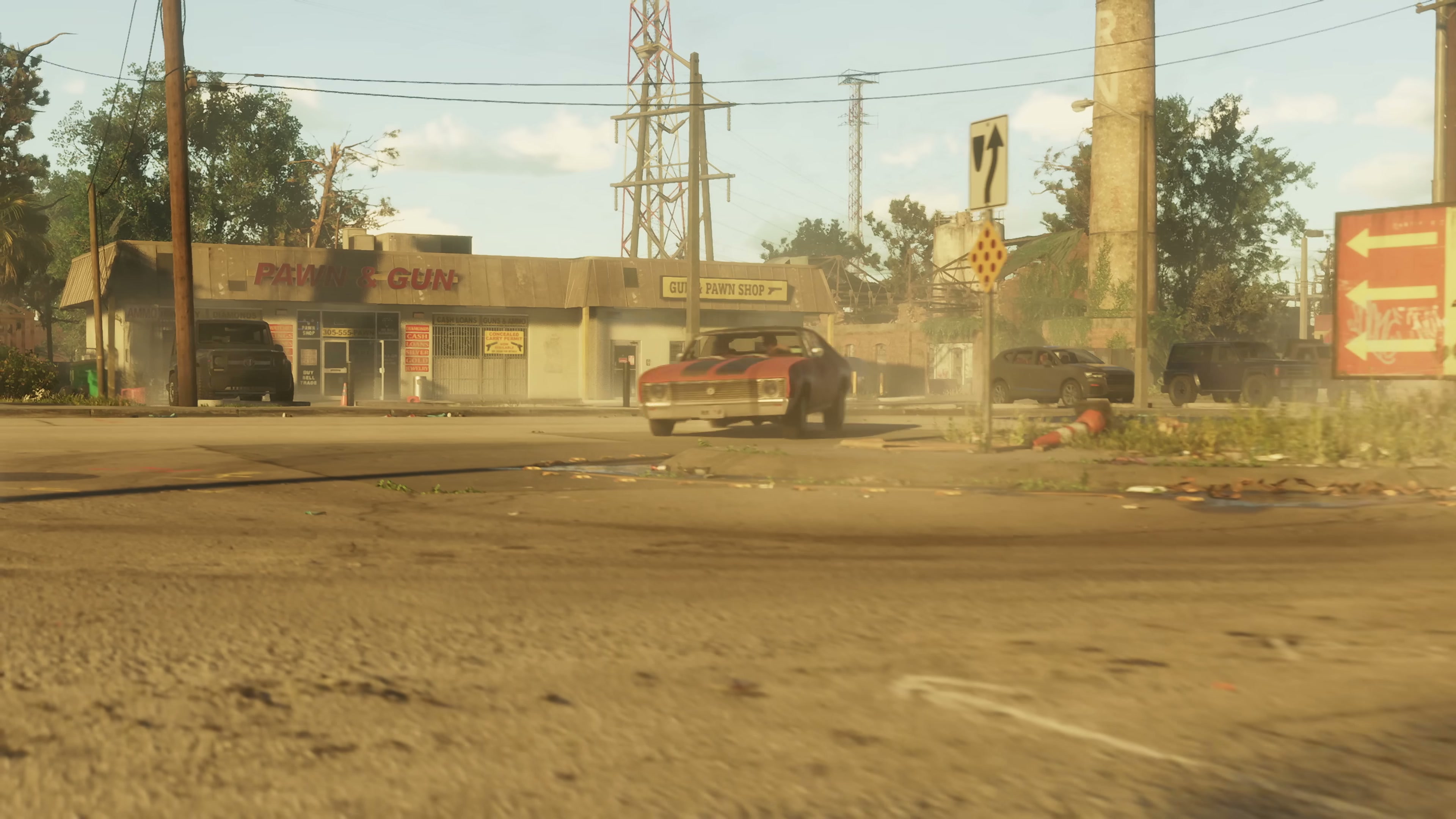 Red muscle car driving past a Pawn-Gun and Guns & Pawn Shop storefront