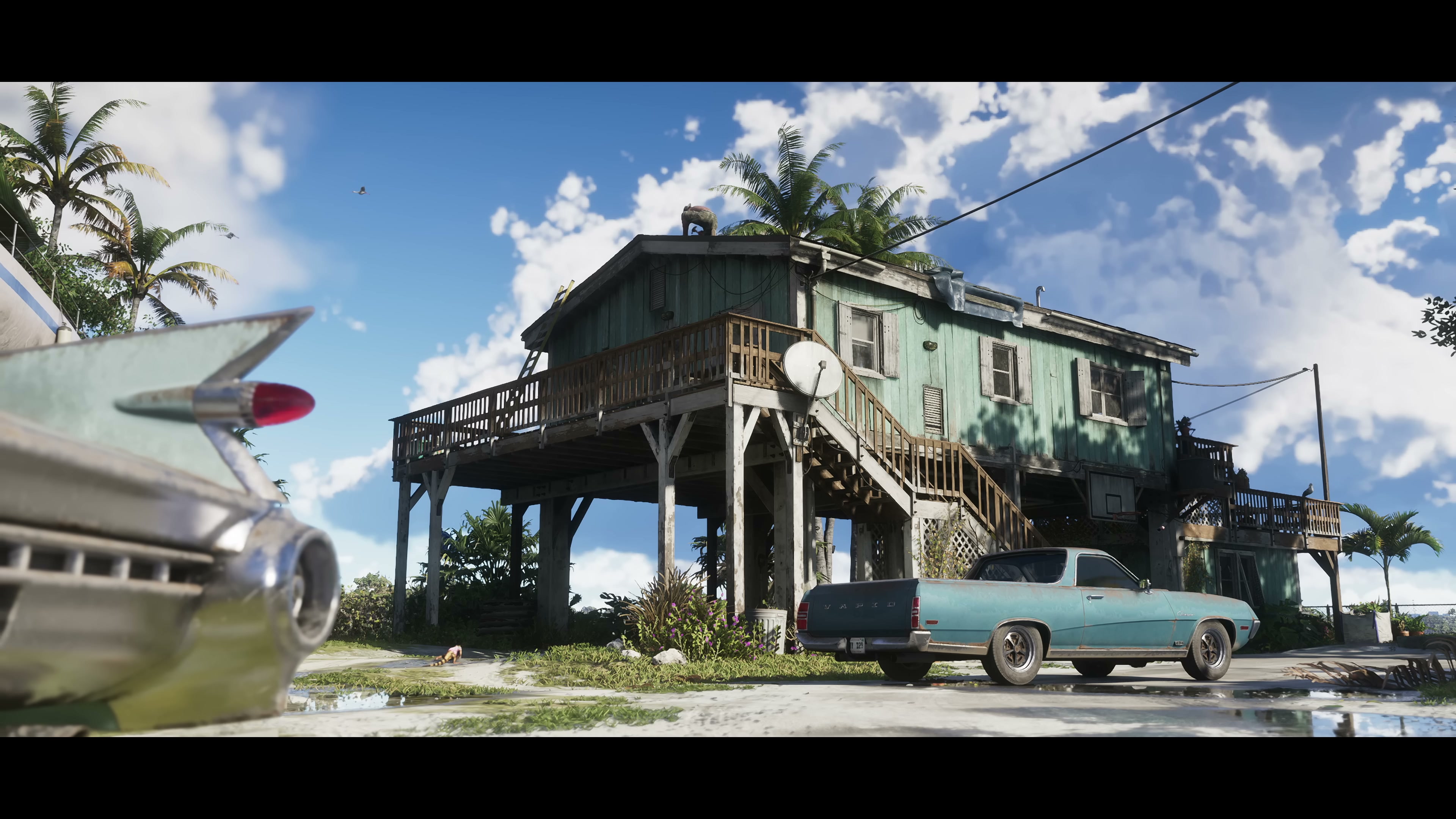 A weathered stilt house in the Leonida Keys with a vintage convertible parked outside.