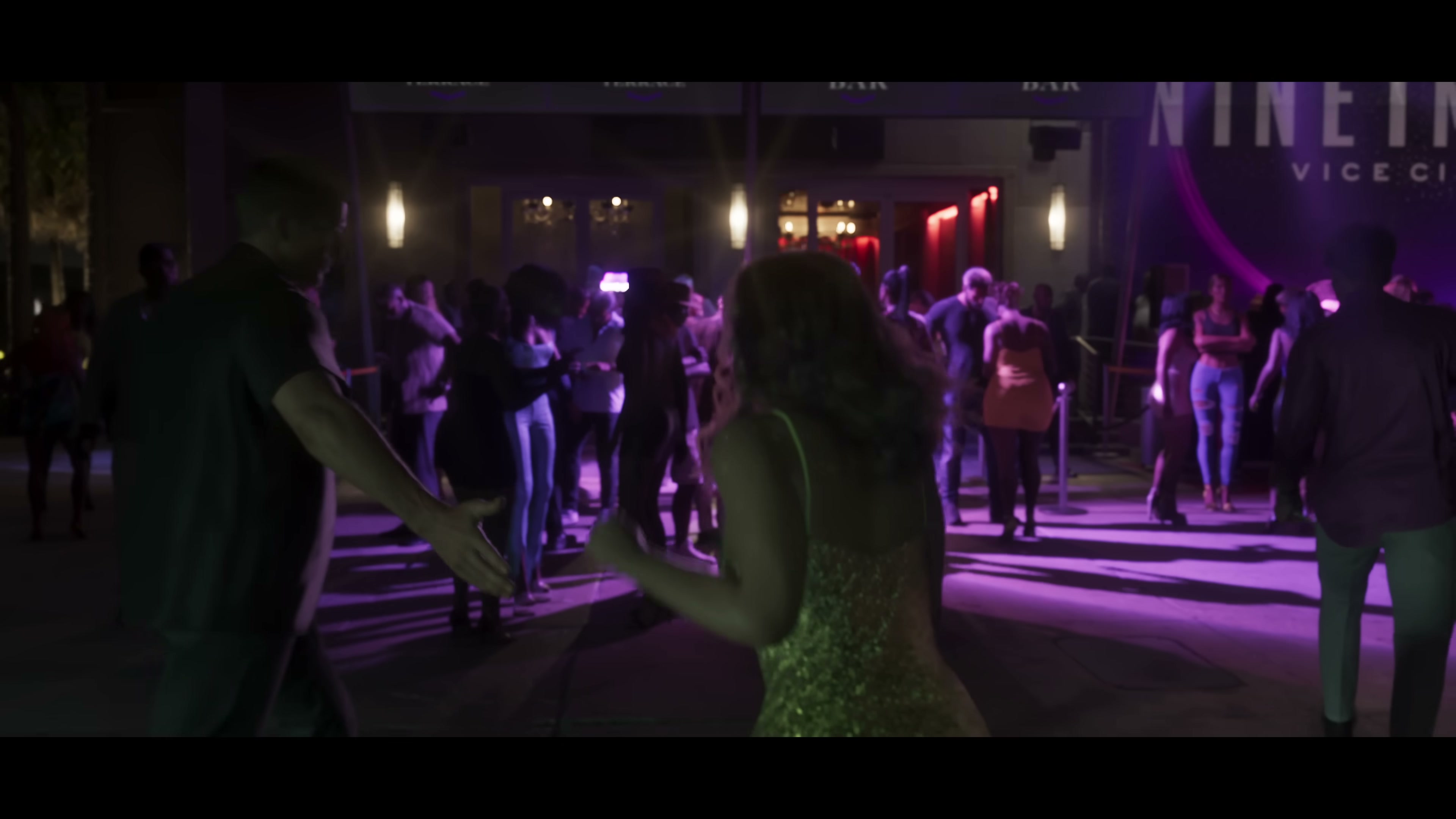 Crowded outdoor Vice City nightclub with purple and pink lighting and 'NINE' signage